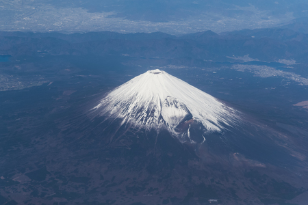 Top of Mountain Fuji with snow in winter season , taken from on airplane after takeoff from Tokyo Haneda international airportの写真素材