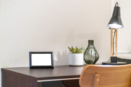 Empty picture frame placed on the desk in the bedroomの写真素材