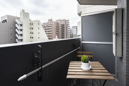 Wooden table for sitting on a small room balconyの写真素材