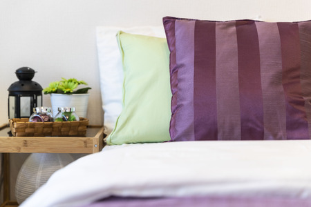 Pillows and cushions on the bed and the head of the bed in the bedroomの写真素材