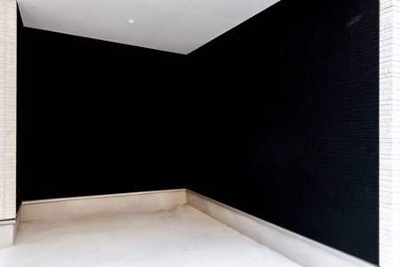Small parking space with black cement wall