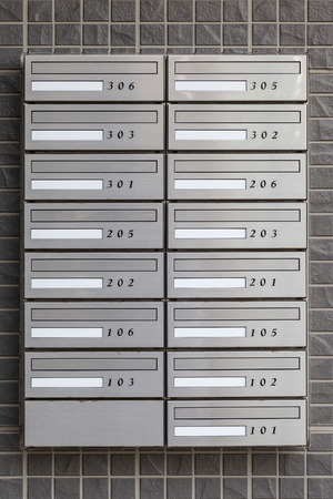 Metal letter box with room number at apartment buildingの写真素材