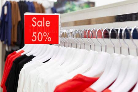 Sale label at the clothes rack In the shirt store at the mall