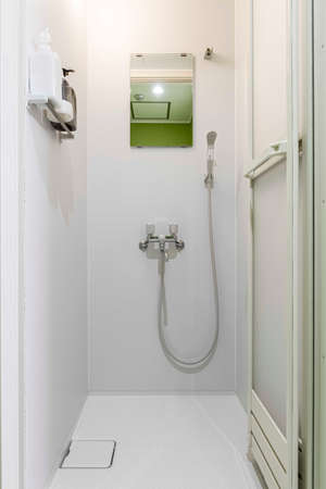 Empty corner rounded shower cabin with closed sliding glass doorの写真素材