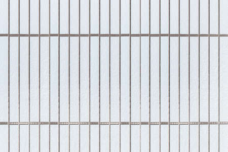 Modern white stone wall with stripes texture and seamless backgroundの写真素材