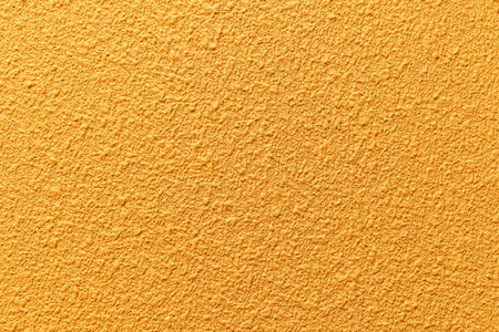 Rough patterned yellow cement wall texture and seamless backgroundの写真素材
