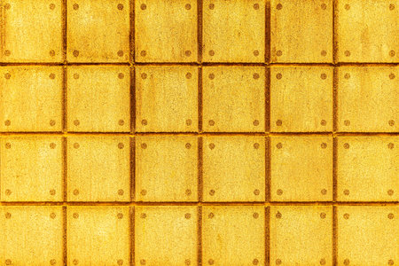 Yellow stone block wall seamless background and pattern texture