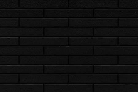 Black stone block wall seamless background and pattern textureの写真素材