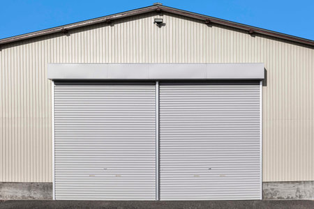 A white shutter door close at an industrial warehouseの写真素材
