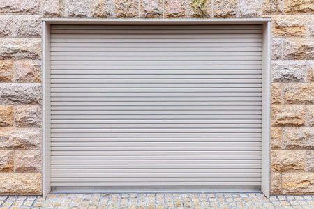 Automatic white roller shutter doors on the ground floor of the house