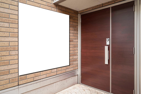 A large blank billboard attached to the entrance of a modern office building