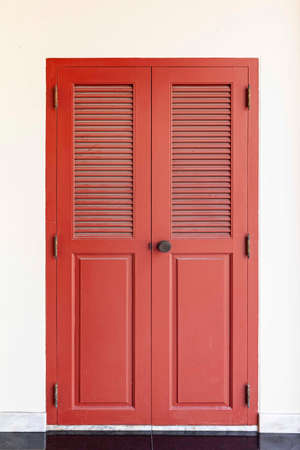 Vintage red wooden door and light cream stucco wallの写真素材