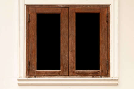 Old brown wooden windows and light cream cement wallsの写真素材