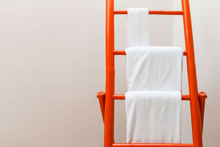 Towel for wiping the hanging bamboo towel rack in the bathroomの写真素材