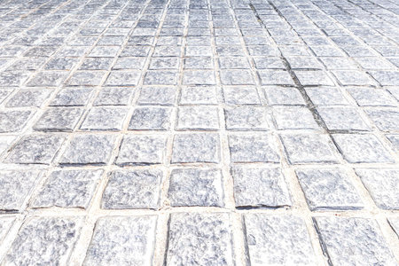 Perspective View Monotone white Brick Stone Pavement on The Ground for Street Roadの写真素材