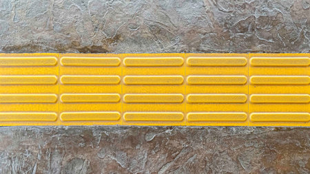 Panorama of Yellow footpath floor tile corridor for the blind pattern and background seamless