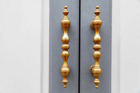 Gold aluminum door handle and white wood doorの写真素材