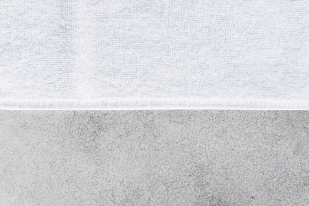 Clean white towels folded on a white wood table.の写真素材