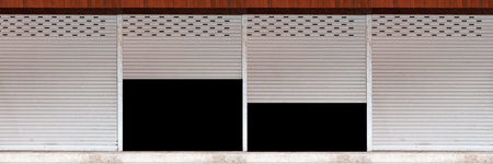 The silver roller shutter door of the store is closed and opened