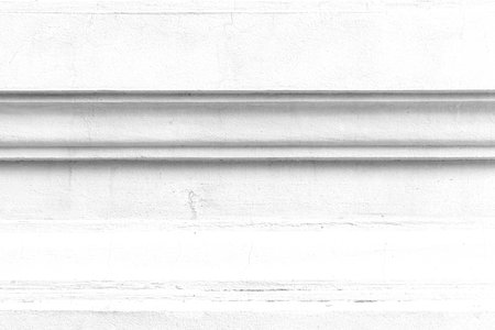 Vintage white painted cement wall with rough surface texture and background seamless