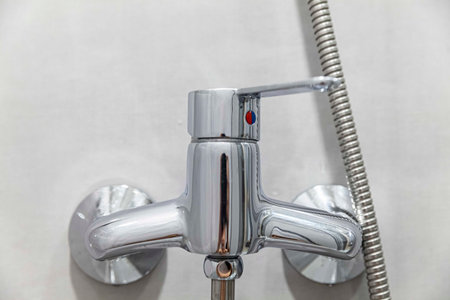 Close-up of modern aluminum shower faucet with lever