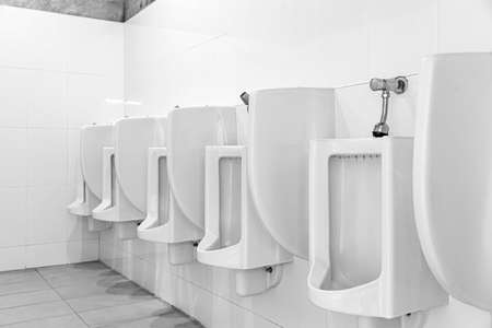 Row of white ceramic urinals in the men's bathroomの写真素材