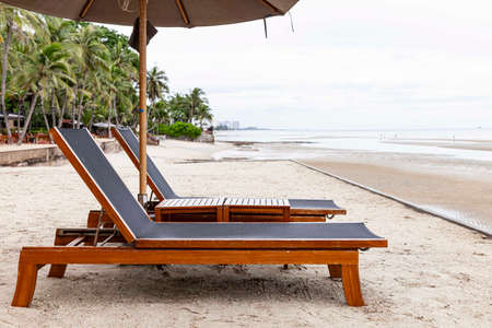 Empty sunbeds at the beach of the hotel in relief of the epidemicの写真素材