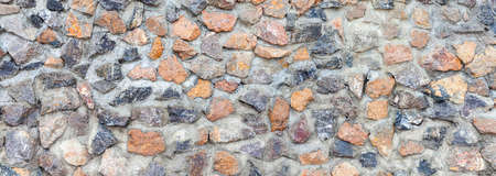 Panorama of Building exterior brown granite block wall texture and background seamlessの写真素材