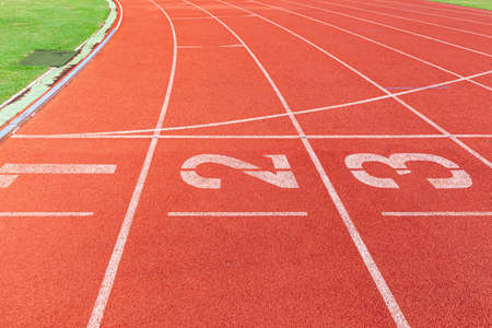 The curved lane in running track or athlete track in stadium. Running track is a rubberized artificial running surface for track and field athleticsの写真素材