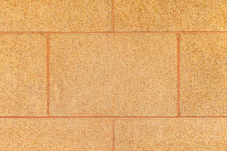 Brown granite tiled wall with vintage pattern texture and background seamlessの写真素材