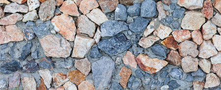 Panorama of Building exterior brown granite block wall texture and background seamless