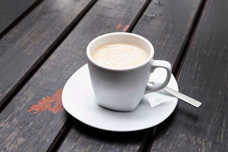 The coffee mug placed on brown wood tableの写真素材