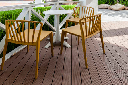 White wooden dining table by the pool inside the resort