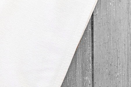 Clean white towels folded on a white wood table.