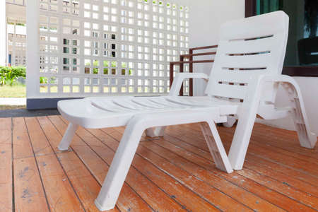 Empty white plastic sun loungers in front of the rooms at the seaside resortの写真素材