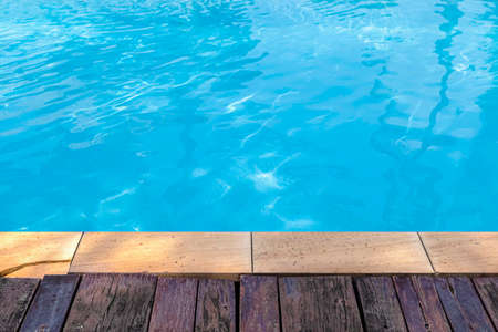 Wide swimming pool and brown stone floor inside the villaの写真素材