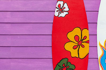 Surfboards and wood fences decorate the beachfront locationの写真素材