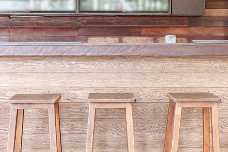 Empty Tall brown wood chair Placed at the bar counter by the seaの写真素材