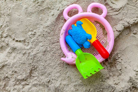 Plastic children ' s toys on the beach sandの写真素材