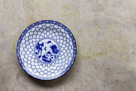 Blue and white patterned plates on the stone tableの写真素材