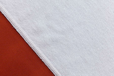Clean white towels folded on brown sofaの写真素材