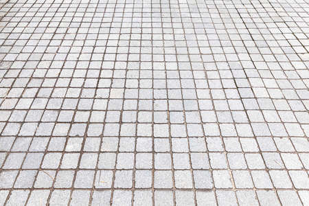 Perspective View Monotone white Brick Stone Pavement on The Ground for Street Roadの写真素材