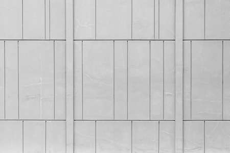 The exterior wall of the cement building is painted white with a line pattern texture and background seamlessの写真素材
