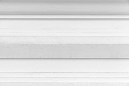 Vintage white painted cement wall with rough surface texture and background seamless