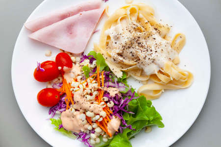 Western breakfast plate, salad, pasta and hamの写真素材
