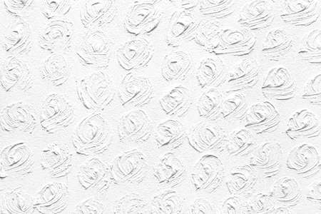 The cement wall is painted white with a circular pattern texture and background seamlessの写真素材