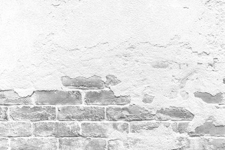 Old cement wall painted white, peeling paint texture and backgroundの写真素材