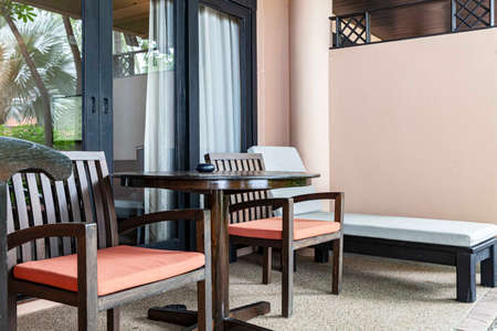 Brown wooden chairs and brown wood table on the balconyの写真素材