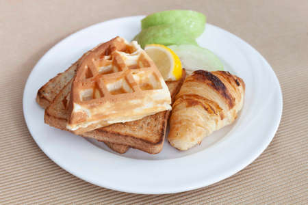 Western breakfast set, toast, croissants, waffles and fresh fruitの写真素材