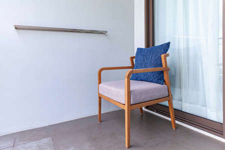 Brown wooden chairs and blue cushions on the balconyの写真素材